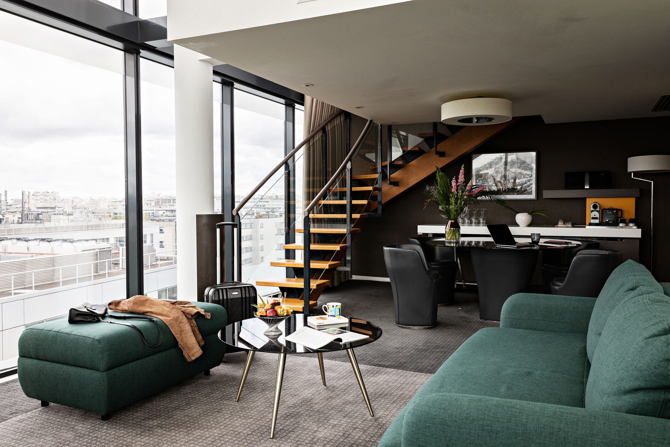 Suite with large sofa, island table, and city view
